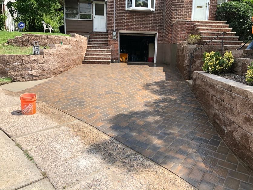 Finished paver driveway installation at a residential home in Leonia, Bergen County, New Jersey by Masonry Pro Construction.