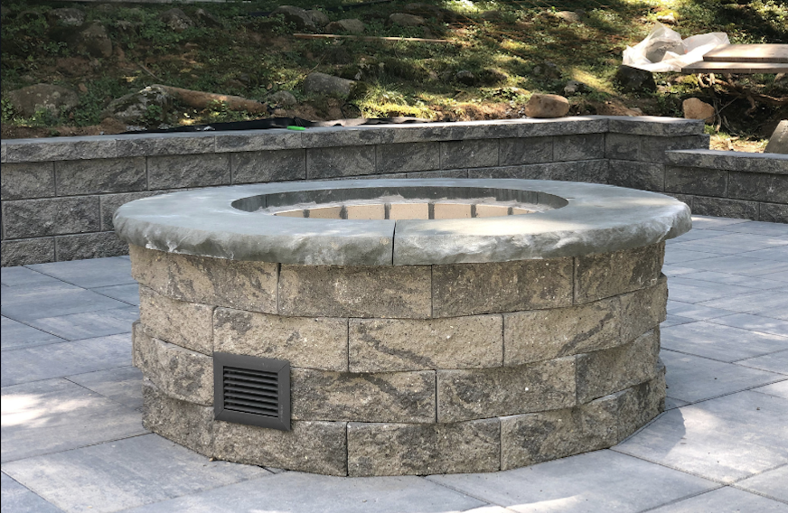 Newly installed block fire pit on a paver patio in Essex Fells, Essex County, NJ, by Masonry Pro Construction.