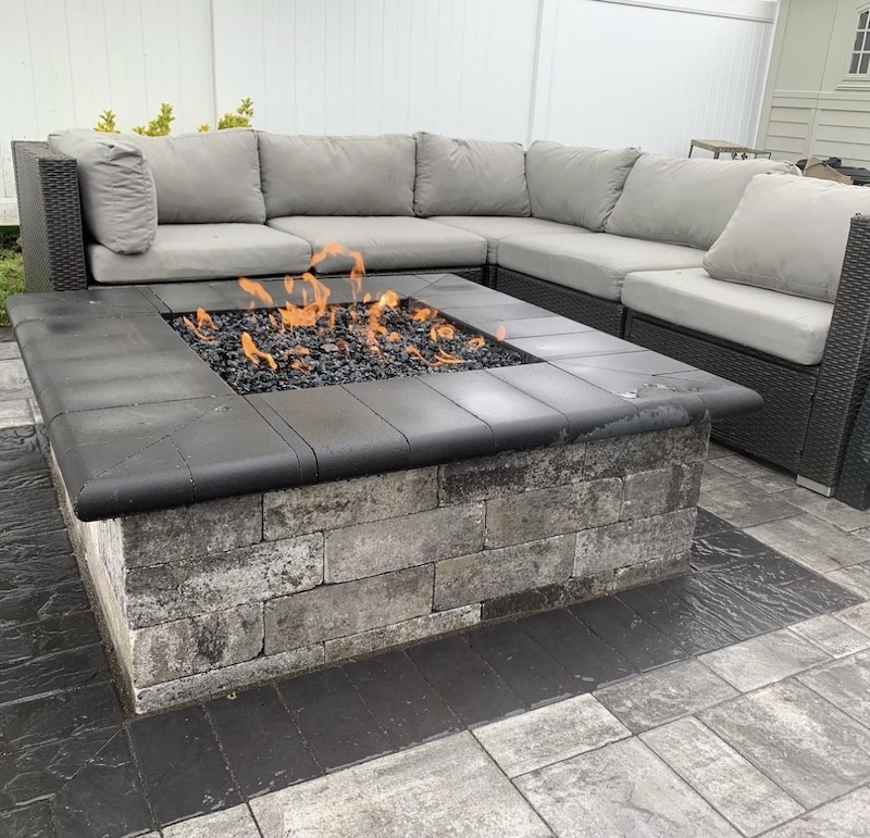 Outdoor fire pit with flickering flames and gray sectional seating at Gravel Hill Road, Kinnelon, Morris County, New Jersey, 07405