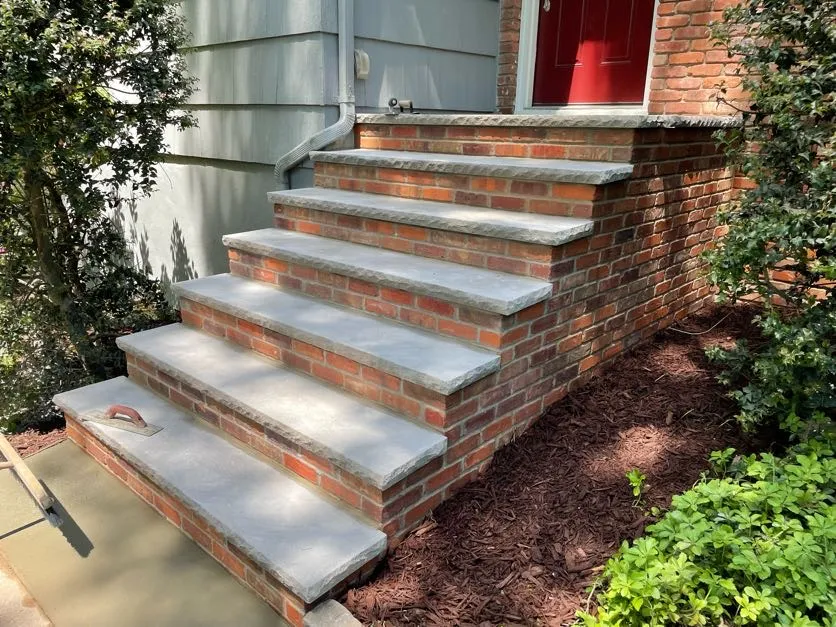 Newly repaired masonry steps leading to a red door in North Caldwell, Essex County, NJ