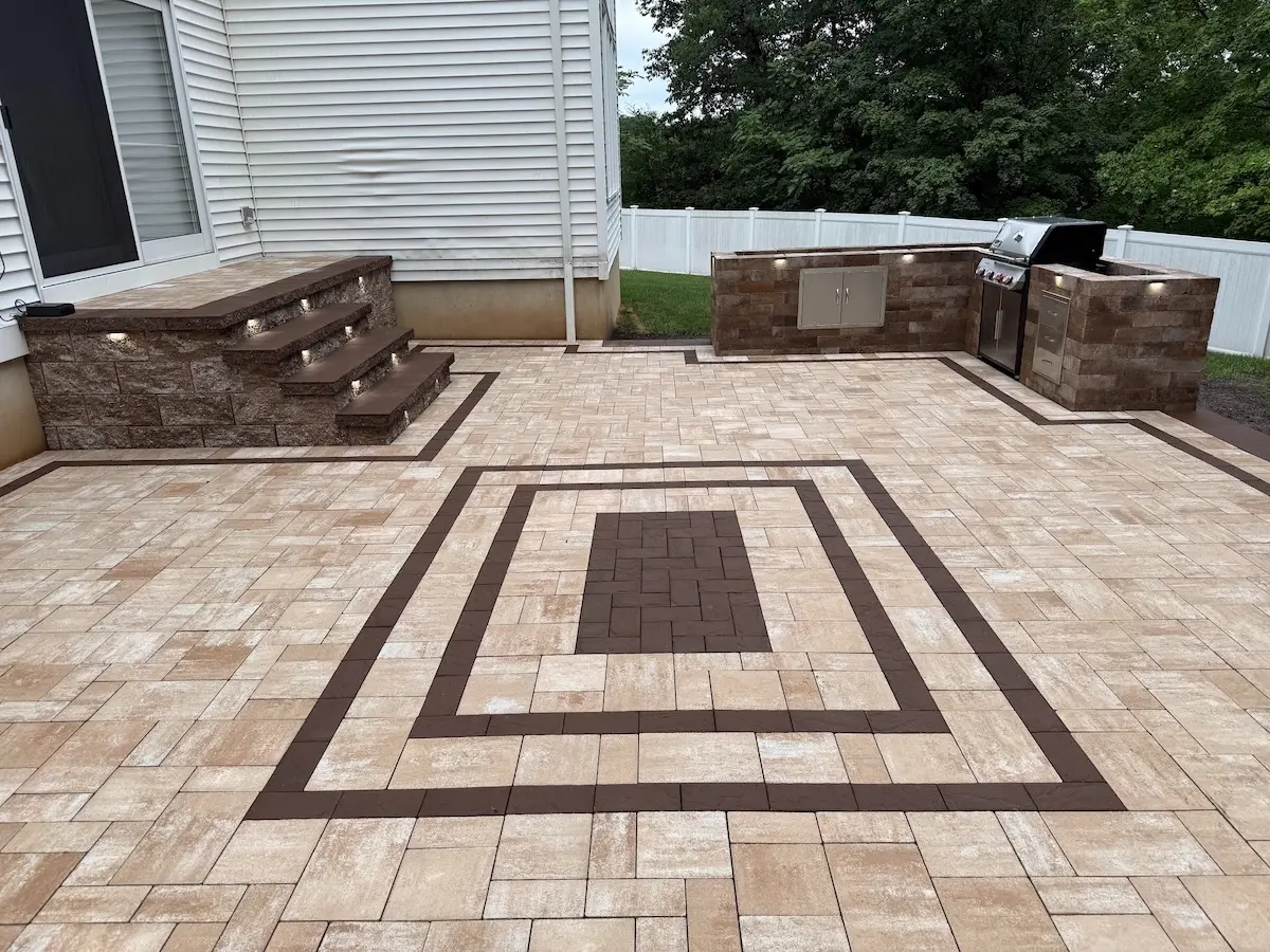 Newly installed patio pavers with outdoor kitchen, lighting, and steps in North Haledon, Passaic County, NJ, by Masonry Pro.