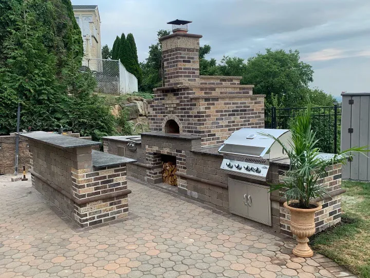 Custom brick outdoor kitchen with built-in grill and oven in Totowa, Passaic County, NJ by Masonry Pro Construction