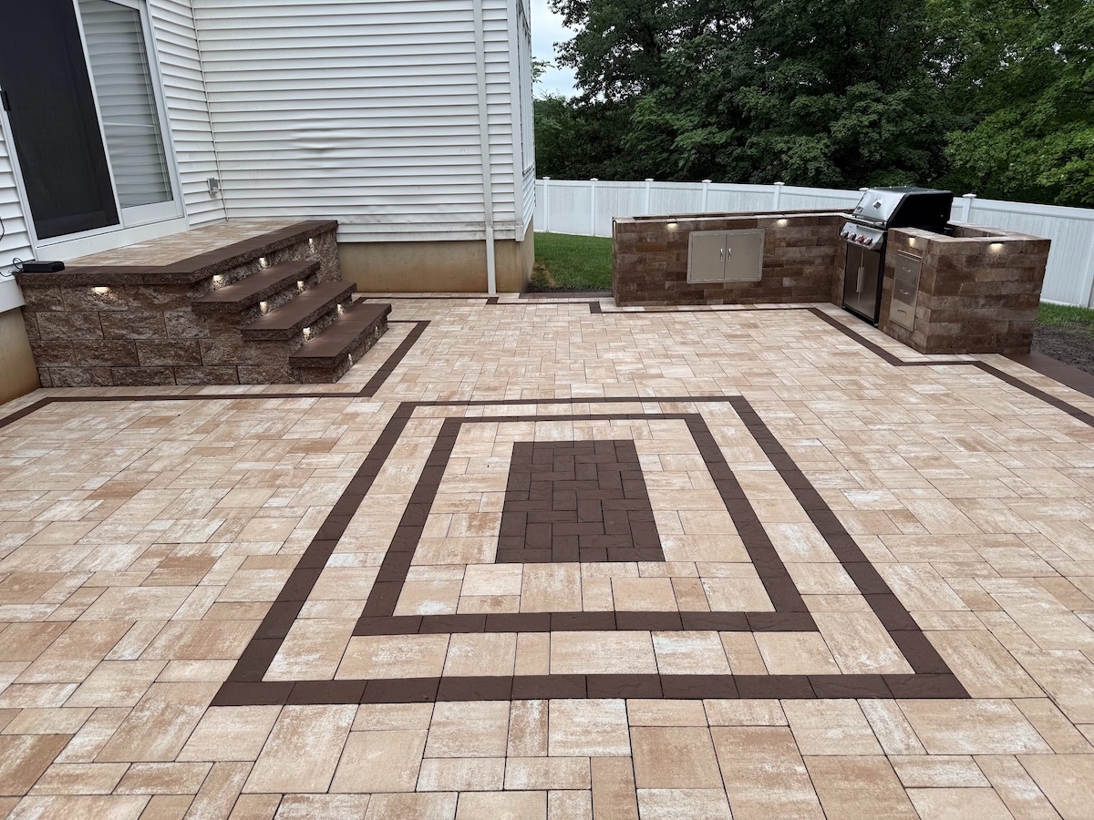 Newly installed patio pavers with outdoor kitchen, lighting, and steps in North Haledon, Passaic County, NJ, by Masonry Pro