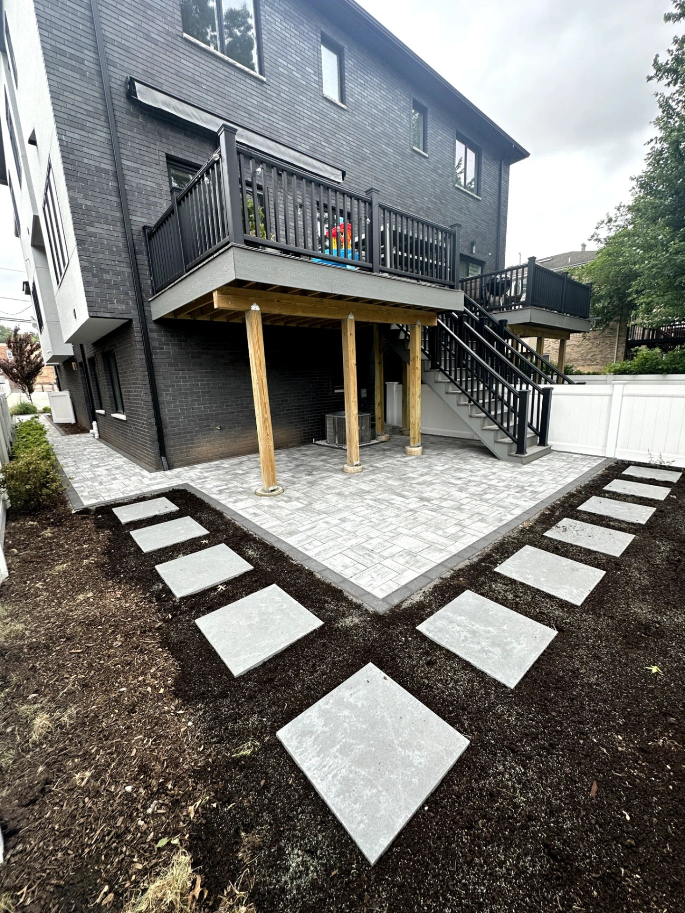 Patio paver installation with stepping stone pathway and landscaping at a home in Palisades Park, Bergen County, NJ, by Masonry Pro Construction.