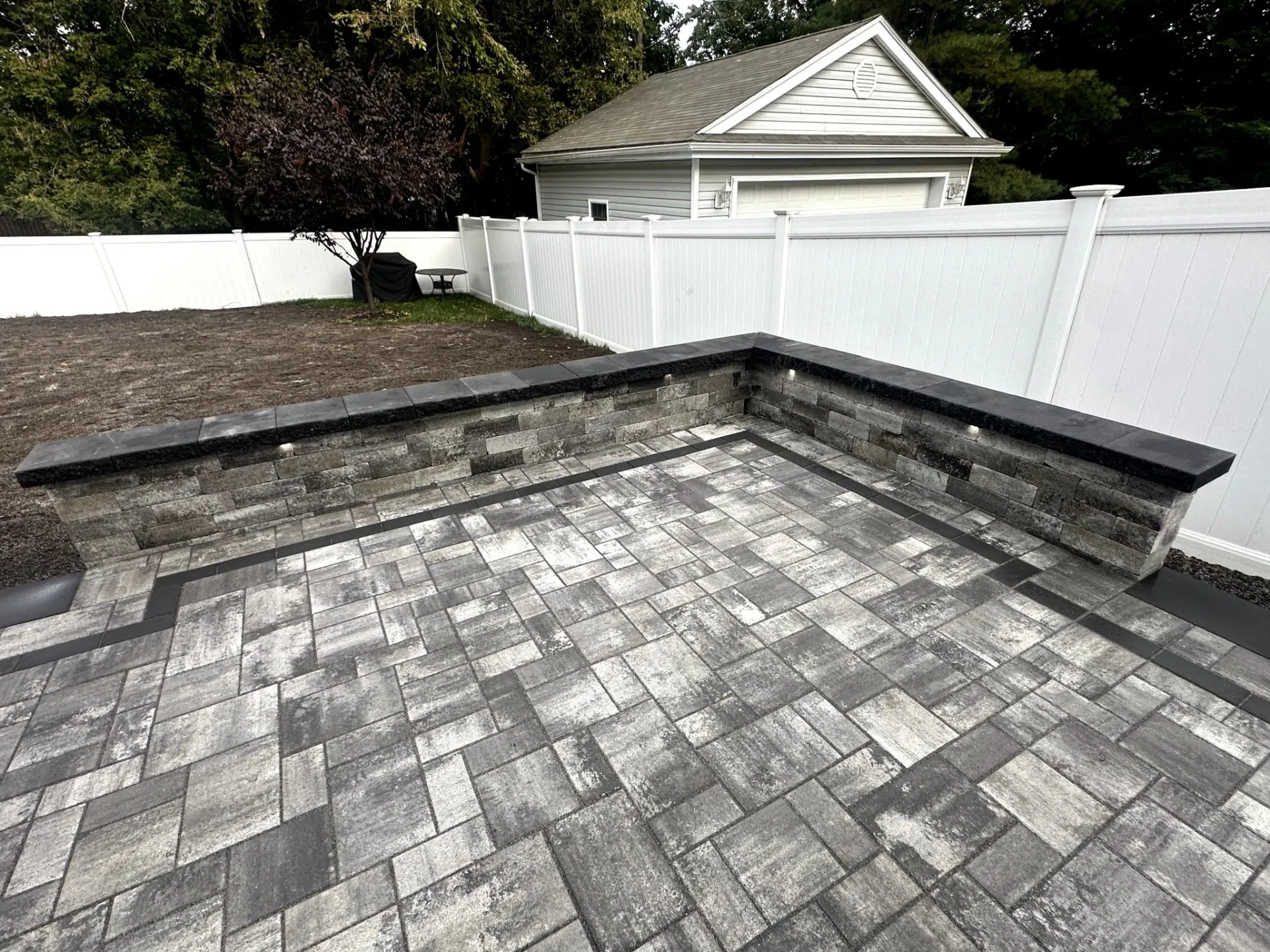 Newly installed paver patio at a residential backyard in Verona, Essex County, NJ, by Masonry Pro Construction.