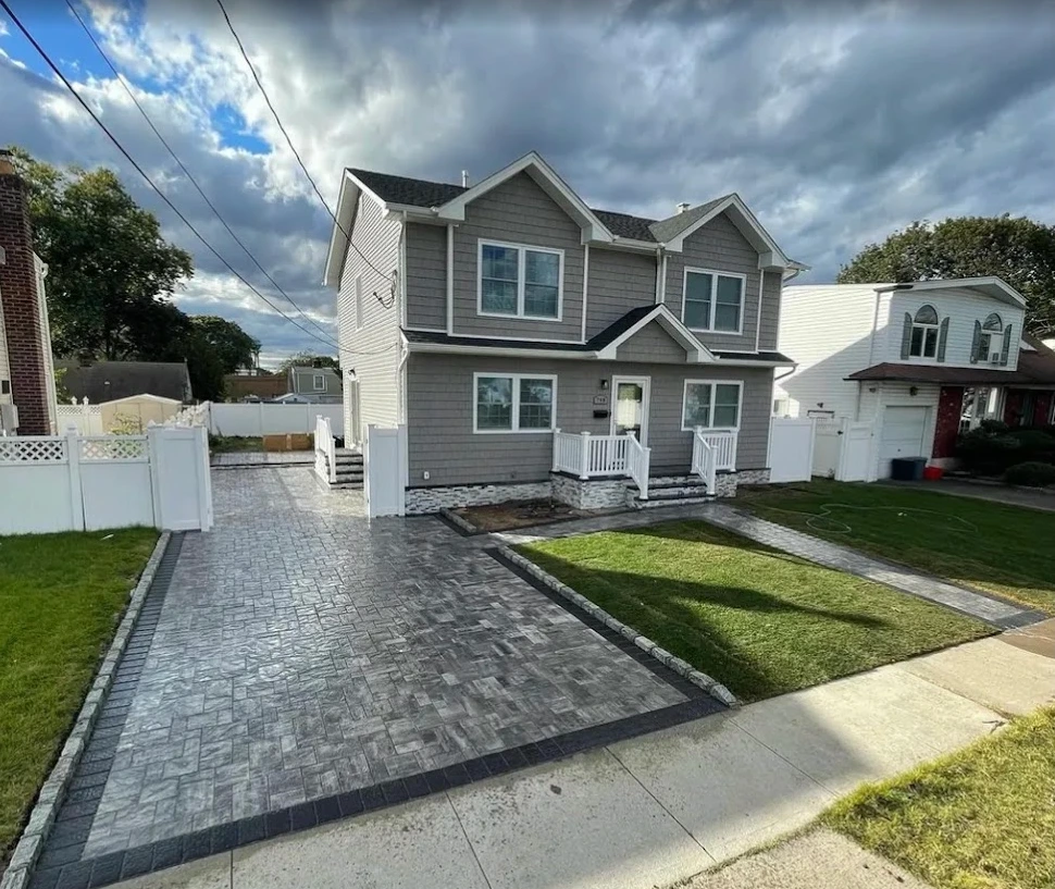 New paver driveway installation with dark border at a residential home in Clifton, Passaic County, NJ, by Masonry Pro Construction.
