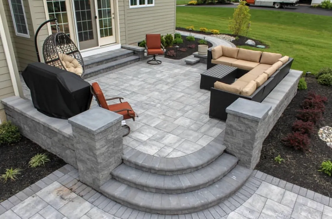 Elevated paver patio with bluestone steps and outdoor furniture in Paramus, Bergen County, NJ, by Masonry Pro Construction.