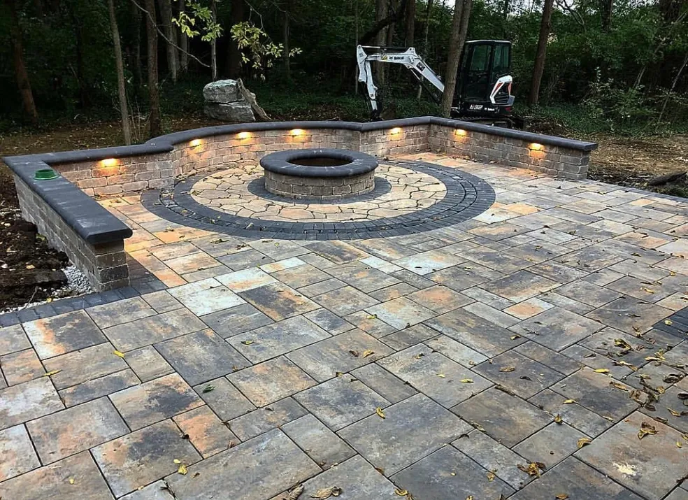 Newly installed paver patio with fire pit and knee wall lighting in Closter, Bergen County, NJ, by Masonry Pro