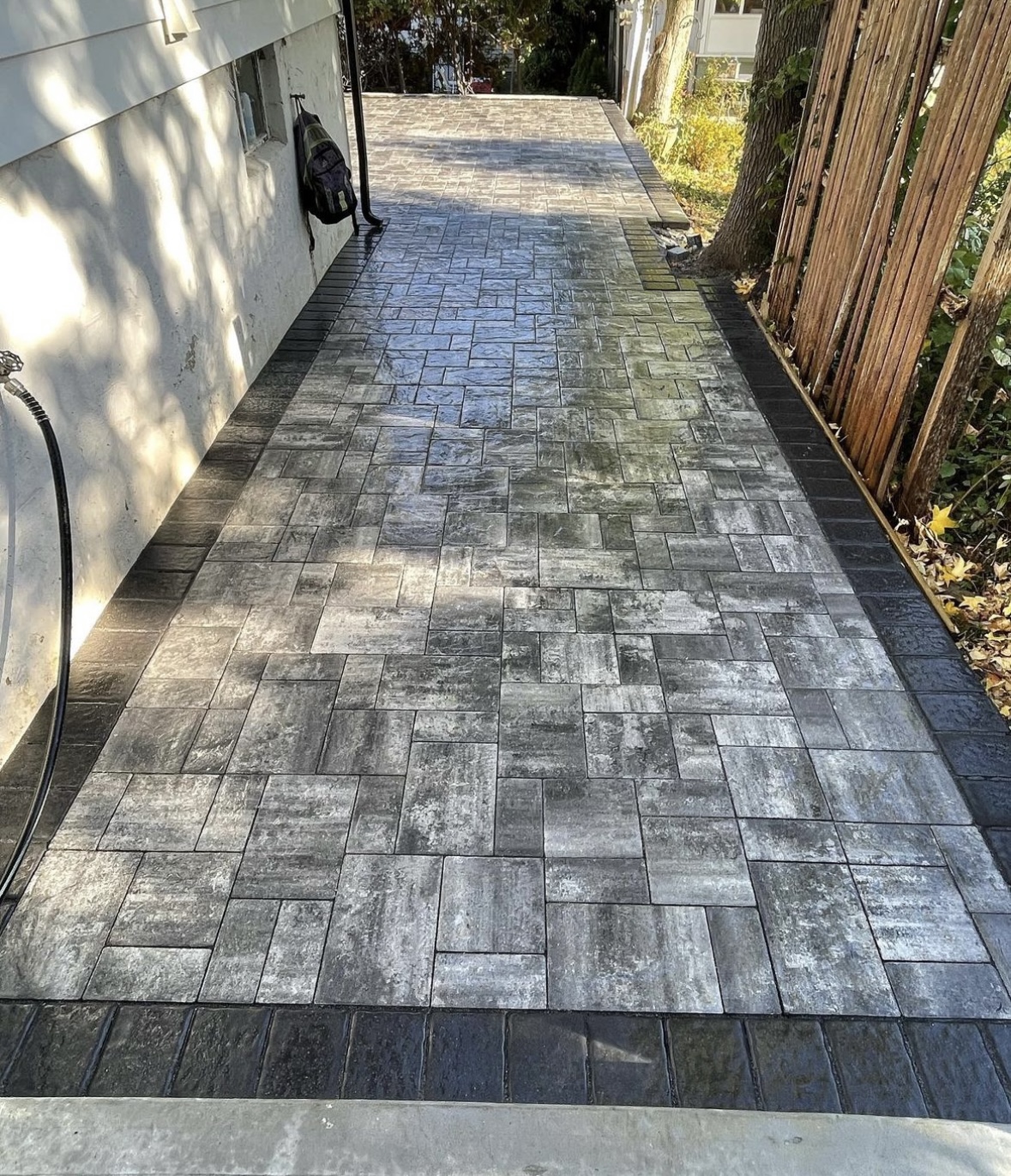New paver patio walkway installation along the side of a home in Bergenfield, Bergen County, NJ, by Masonry Pro Construction.