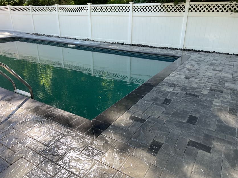Finished paver patio installation with seating area at a residential backyard in Denville, Morris County, New Jersey.