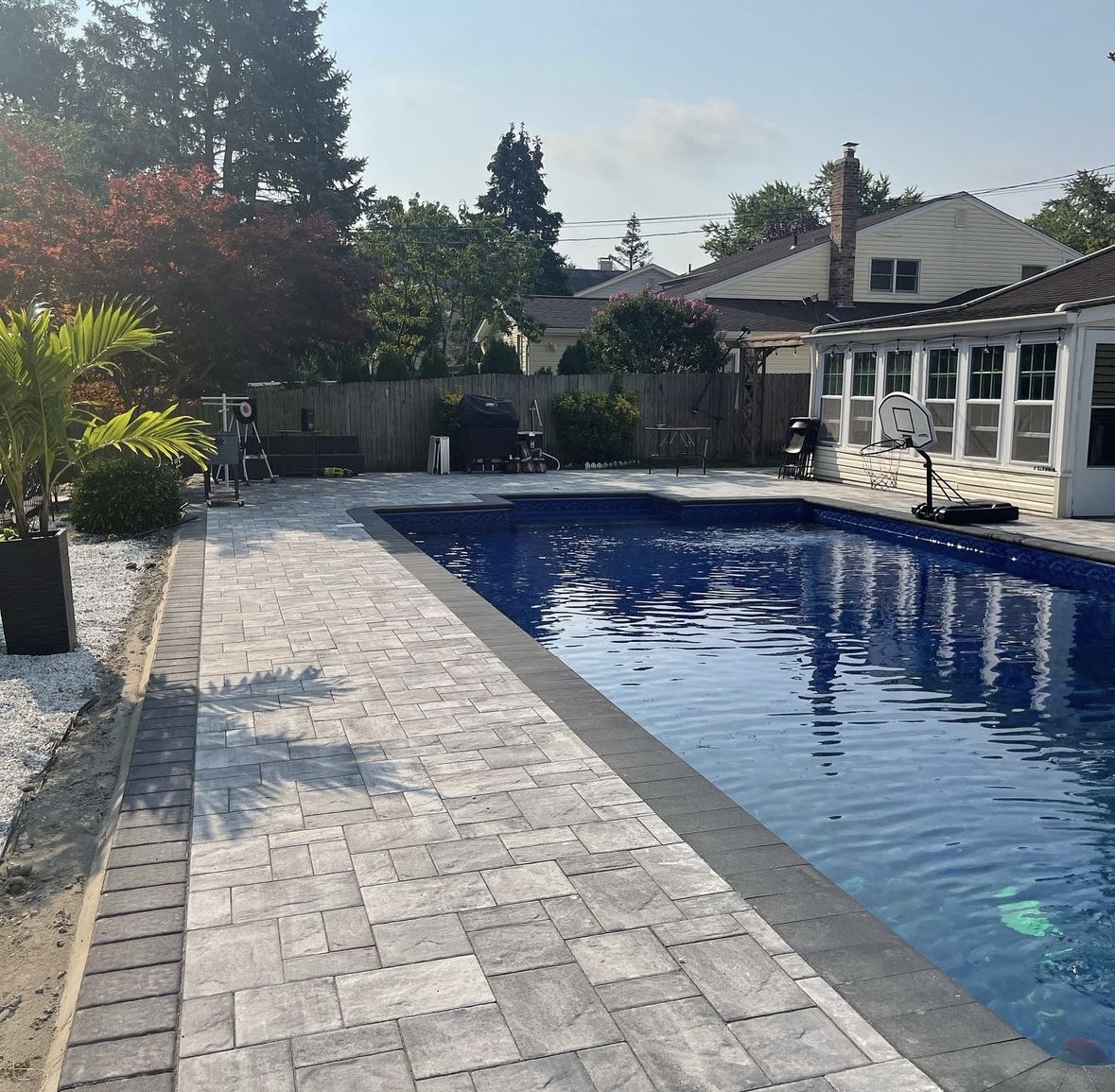 Paver patio and pool deck installation alongside an inground pool in Little Ferry, Bergen County, NJ, by Masonry Pro Construction.