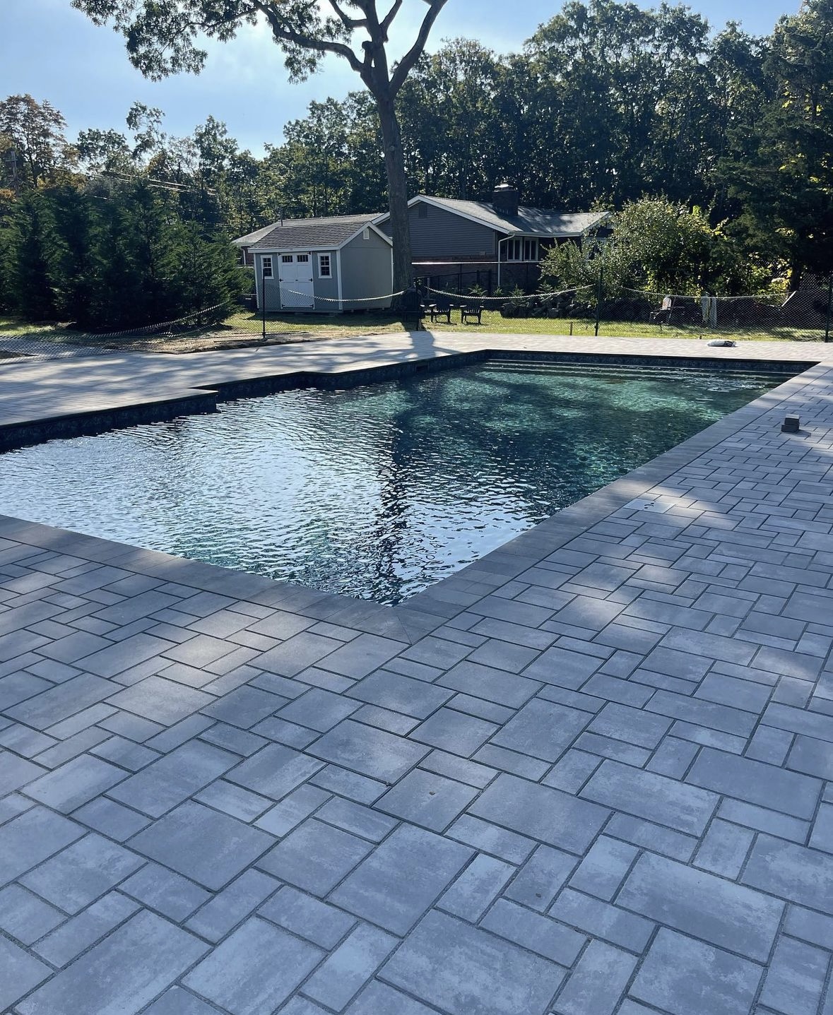 Paver patio installation around a pool at a residential property in Montclair, Essex County, NJ, by Masonry Pro Construction.