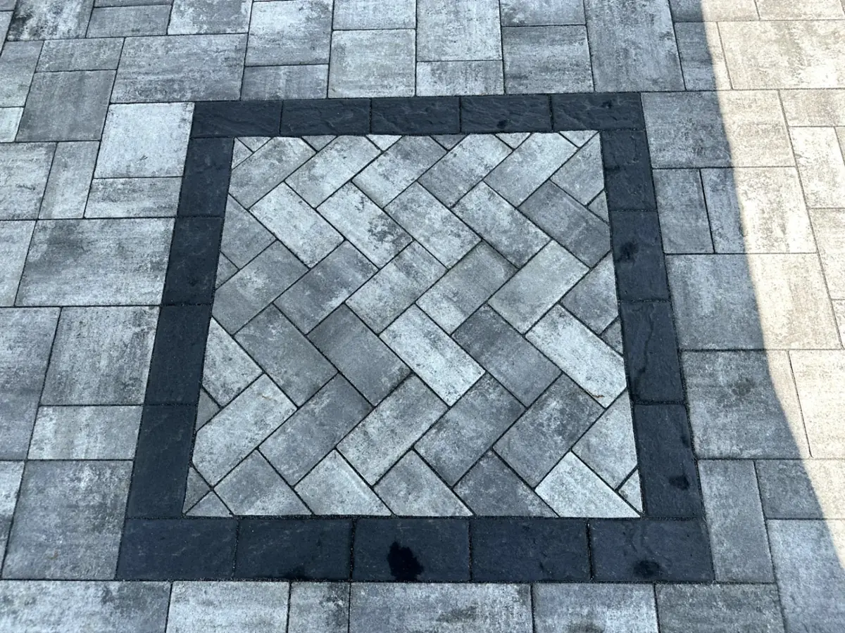 Close-up of herringbone paver patio pattern with dark border at a residential property in Montville Township, Morris County, NJ, by Masonry Pro Construction.