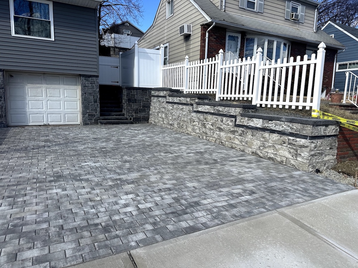 Paver patio installation with retaining wall and white picket fence in Totowa, Passaic County, NJ, Masonry Pro Construction
