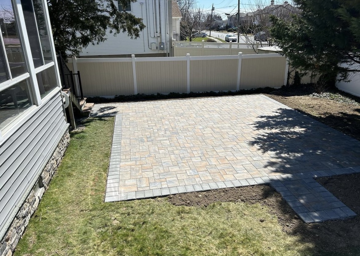 Backyard paver patio installation with herringbone pattern at a home in Wayne, Passaic County, NJ, by Masonry Pro Construction.