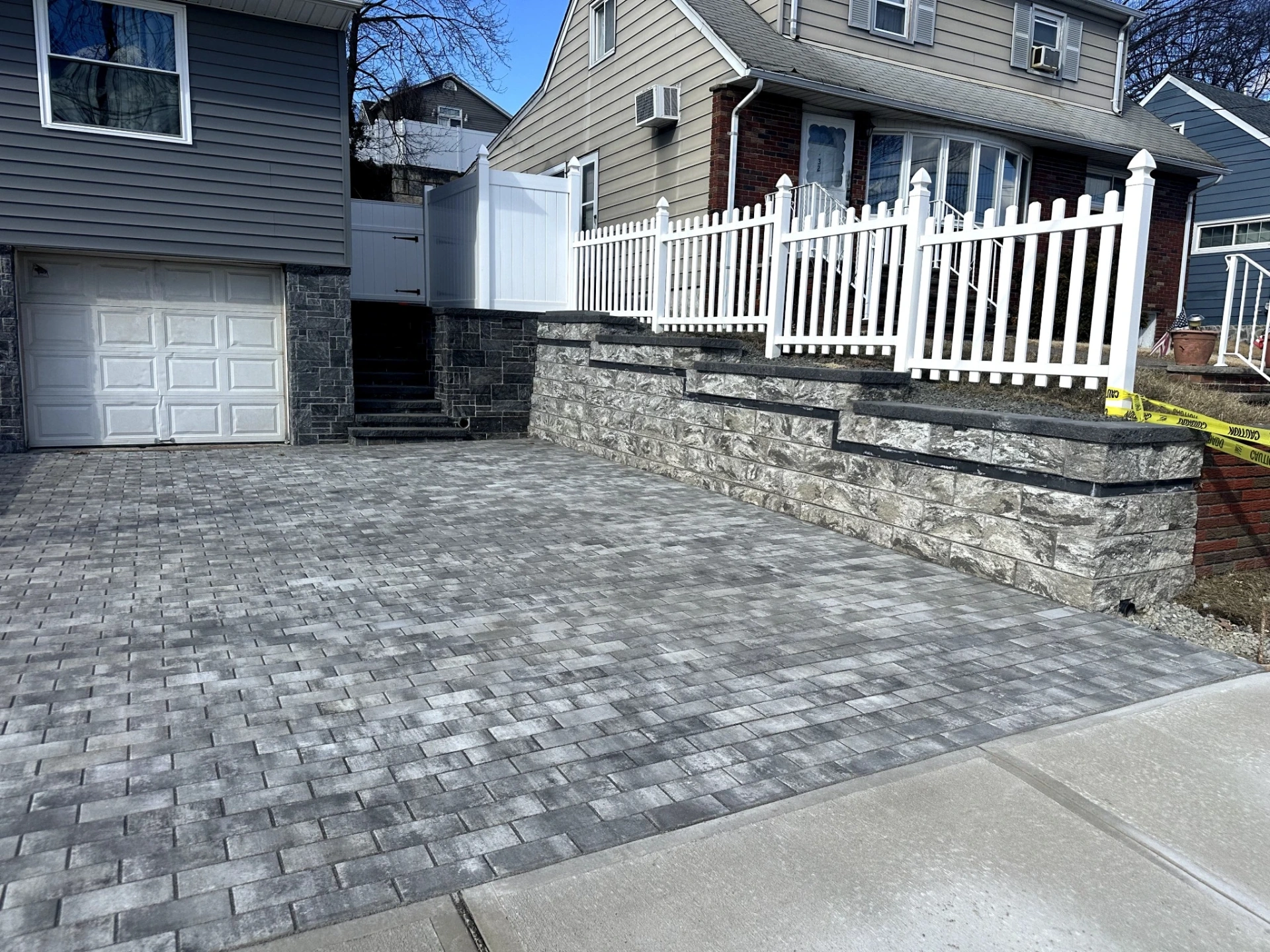 Finished paver patio at a residential home in Totowa, Passaic County, NJ, by Masonry Pro Construction.