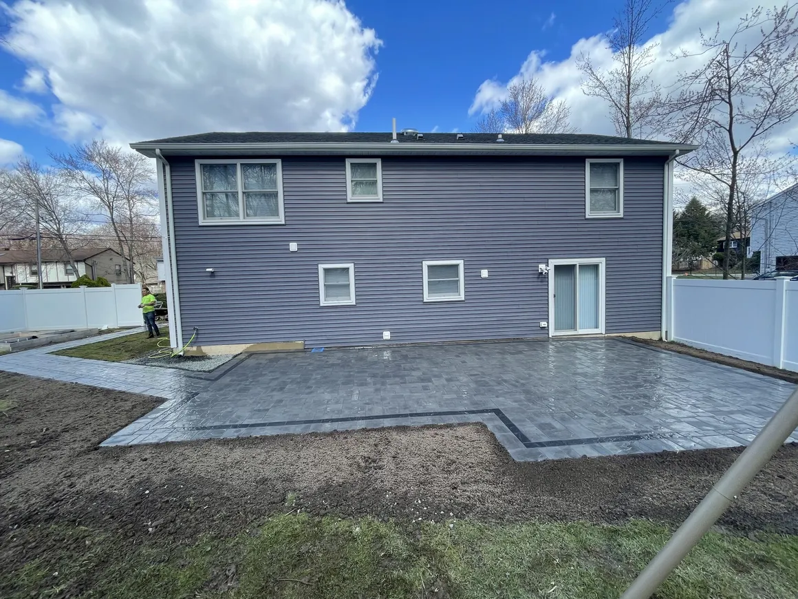 Large backyard paver patio replacement at a home in Wayne, Passaic County, NJ, by Masonry Pro Construction.
