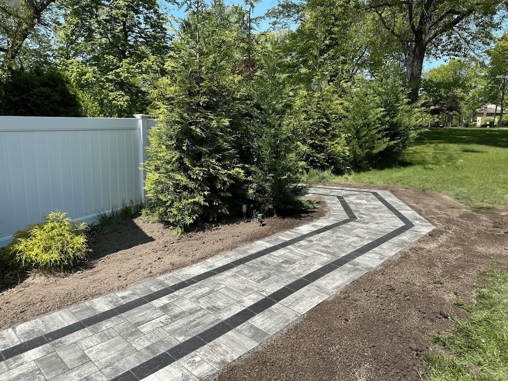 Finished paver walkway at a residential property in Pine Brook, Morris County, NJ, by Masonry Pro Construction.