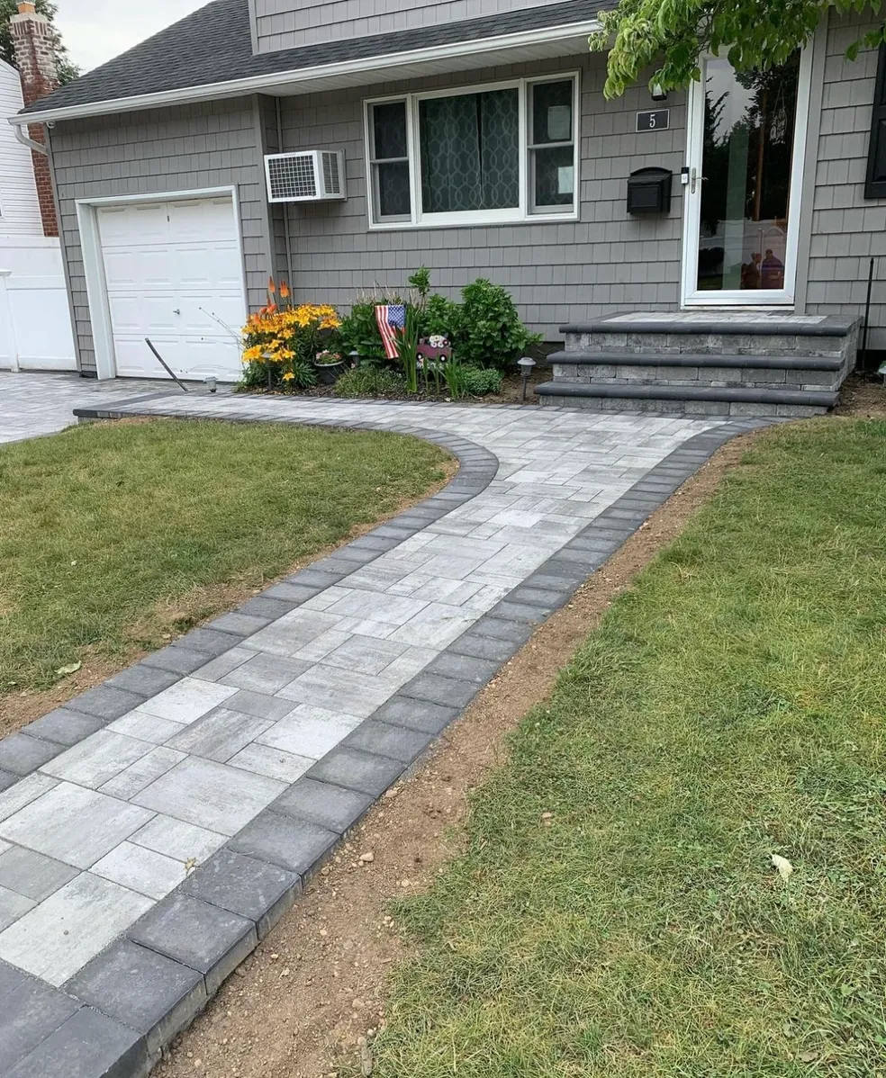 Curved paver walkway installation with matching steps at a residential home in Wayne, Passaic County, NJ, by Masonry Pro Construction.