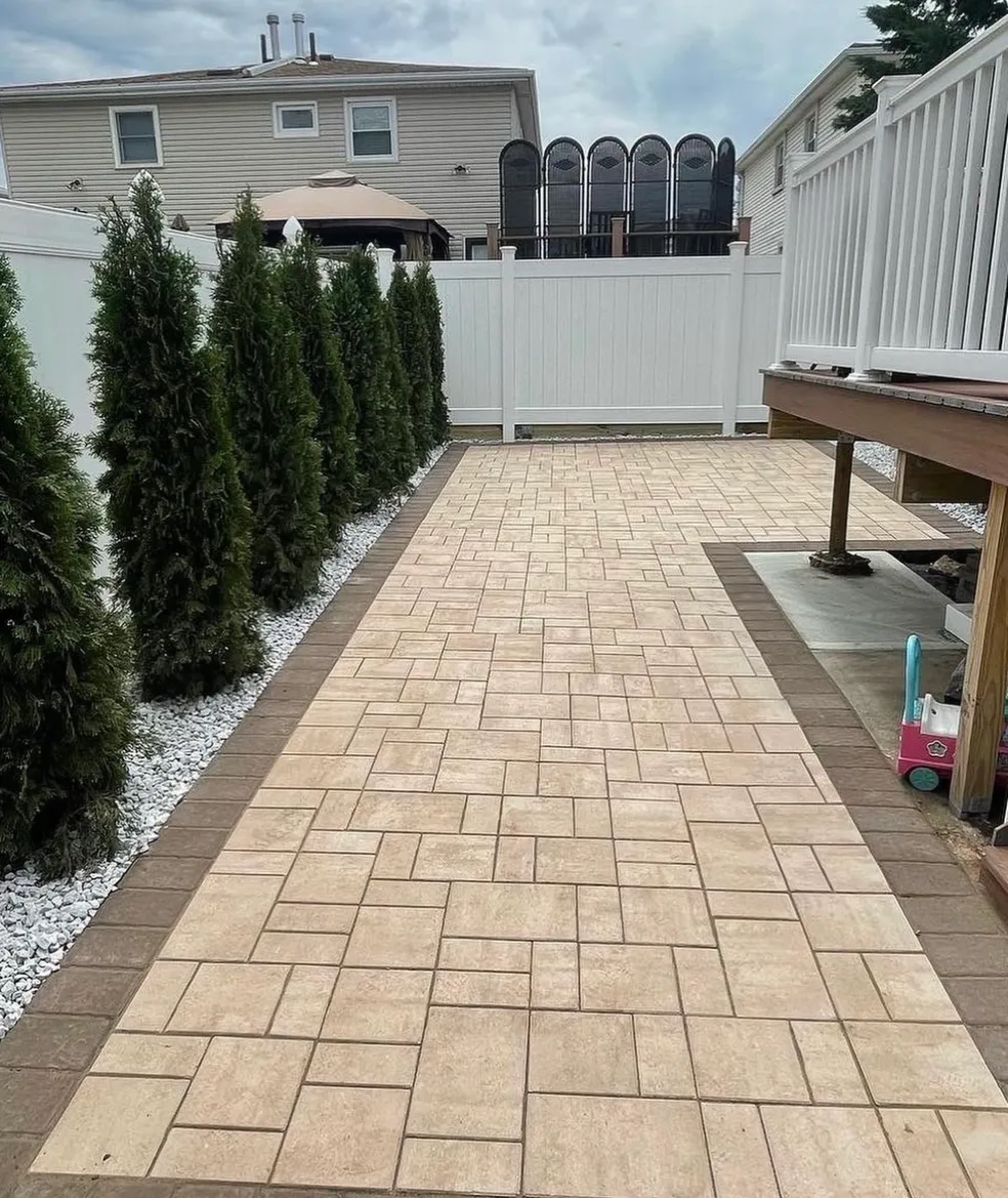 Completed paver walkway installation with decorative border at a residential backyard in Fairfield, Essex County, NJ, by Masonry Pro Construction.
