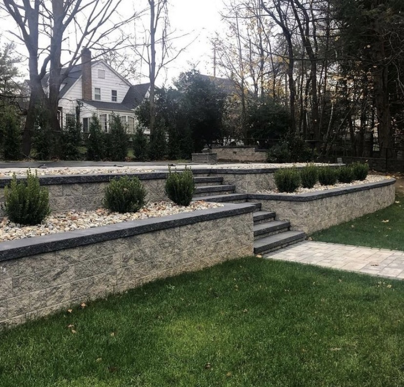Tiered retaining wall hardscape with steps and landscaping in Old Tappan, Bergen County, NJ, by Masonry Pro Construction.