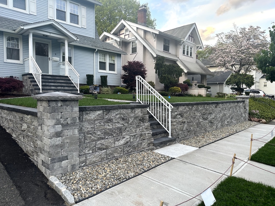 Retaining wall installation at a residential property in Nutley, Essex County, NJ, by Masonry Pro Construction.