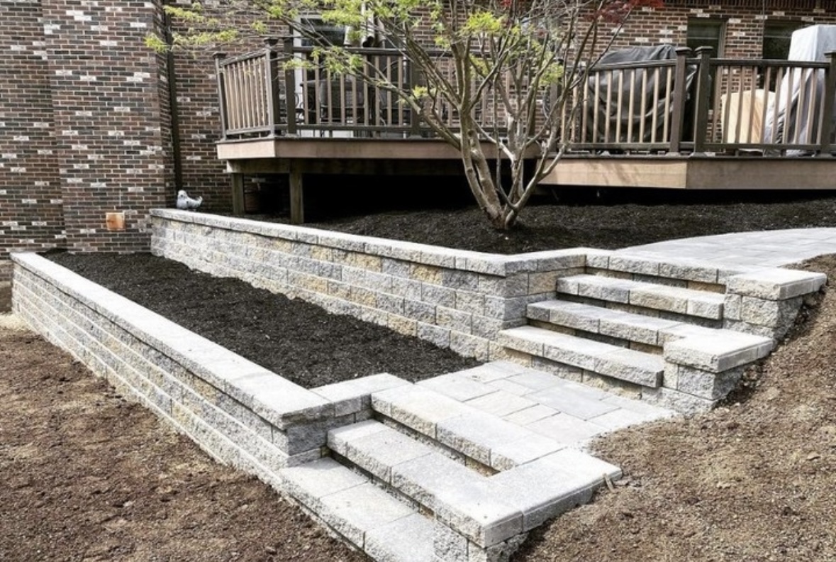 Completed retaining wall installation at a residential property in West Orange, Essex County, New Jersey by Masonry Pro Construction.
