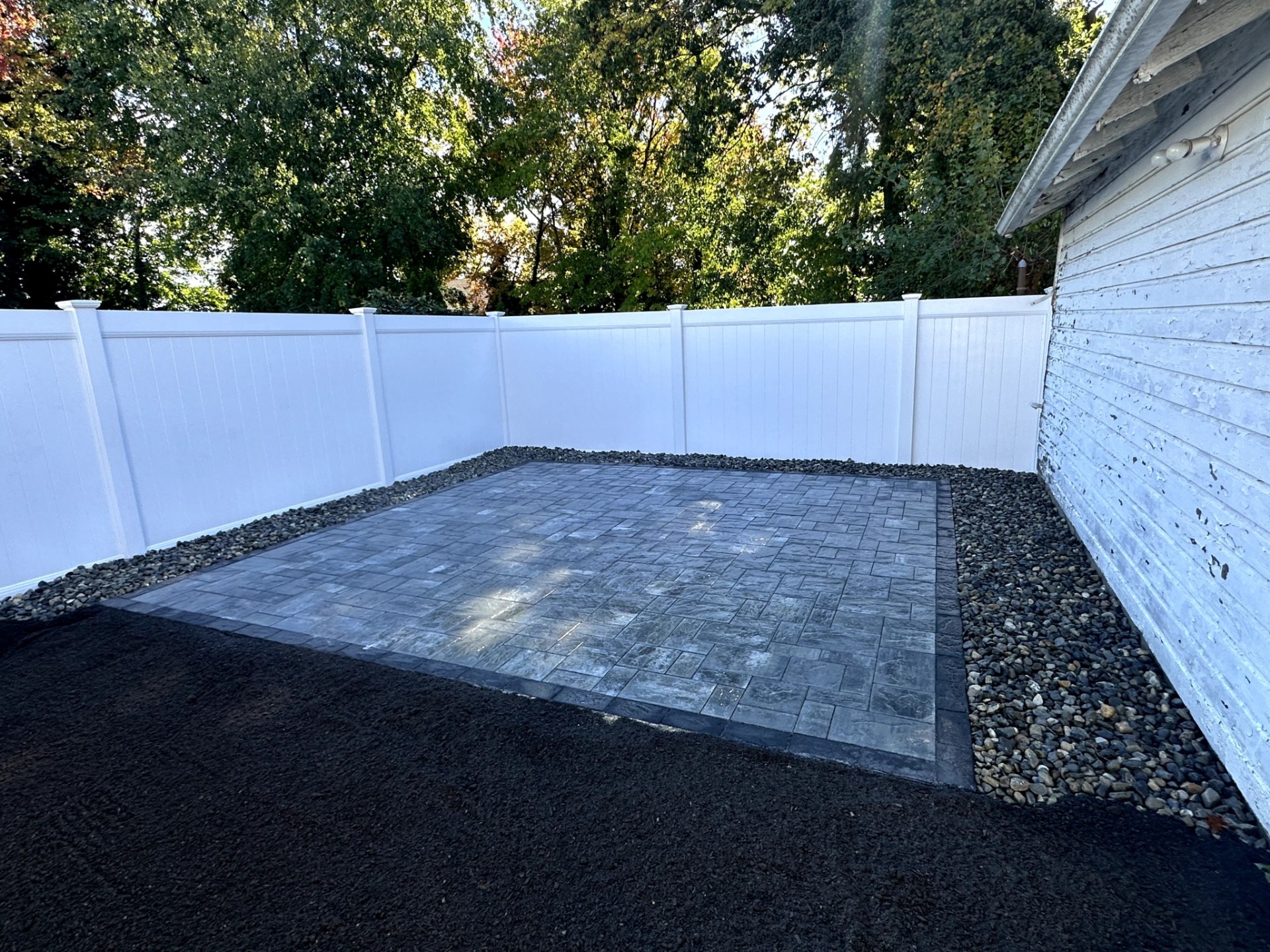 Sealing a paver patio with penetrating waterproofing product in Nutley, NJ.