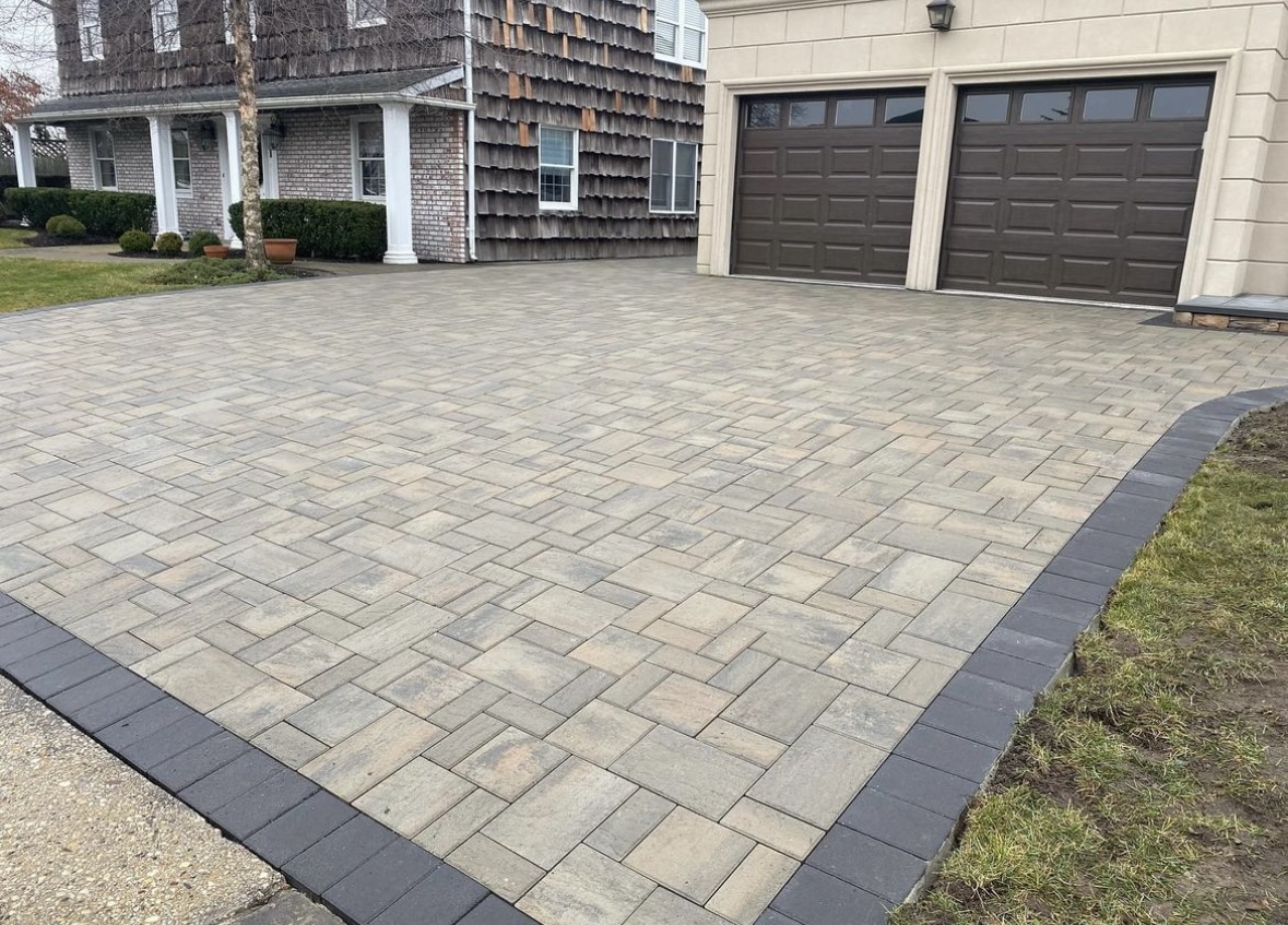 Stamped concrete driveway leading to a house with two garage doors in West Milford, NJ