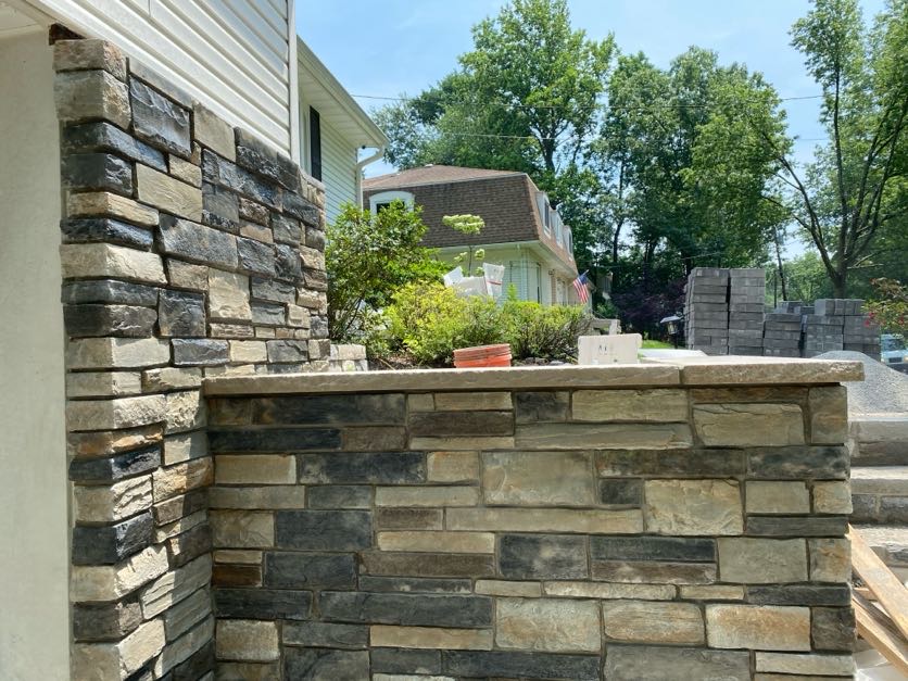 Stone masonry wall construction at a residential property in Maywood, Bergen County, NJ, by Masonry Pro Construction.