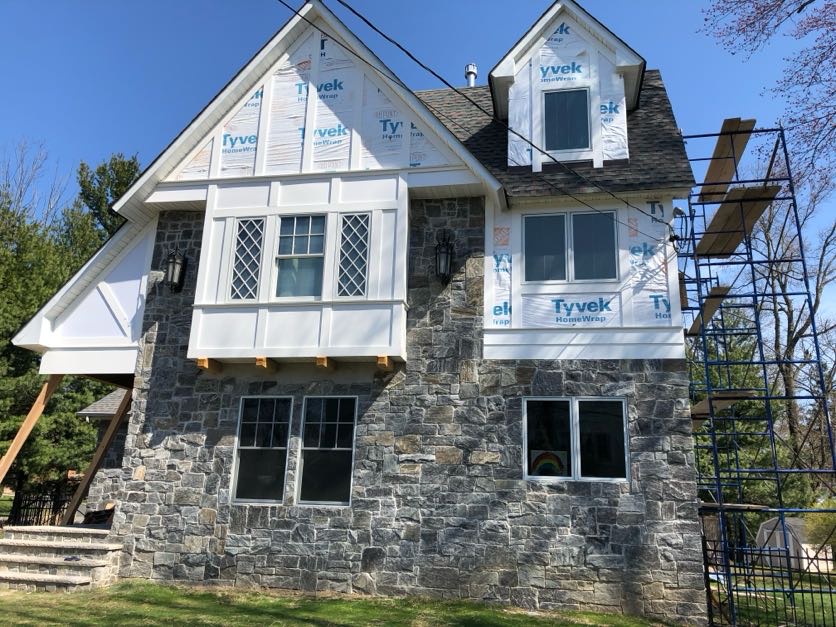 Stone masonry repair on a residential home with new windows in North Caldwell, Essex County, NJ, by Masonry Pro