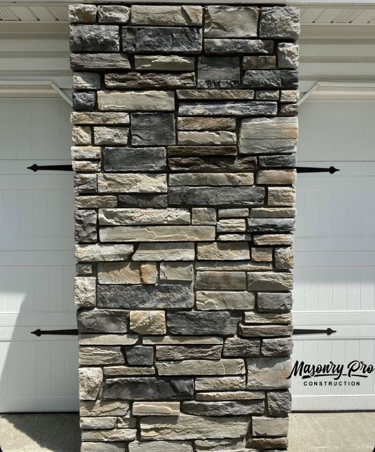 Completed stone veneer installation on a home foundation in Paramus, Bergen County, New Jersey by Masonry Pro Construction.