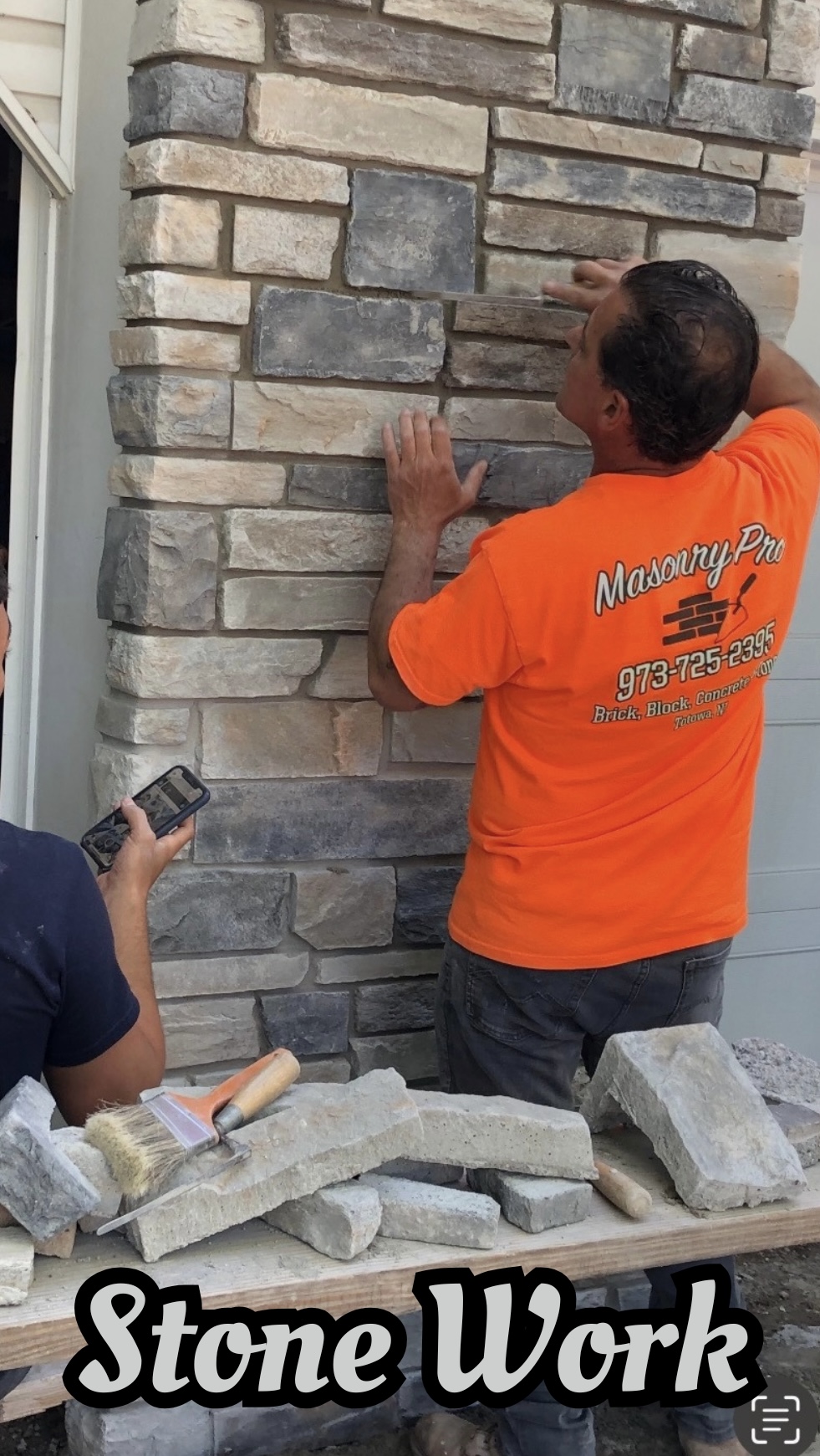 Masonry contractor performing stone work on a residential exterior in Totowa, Passaic County, NJ.
