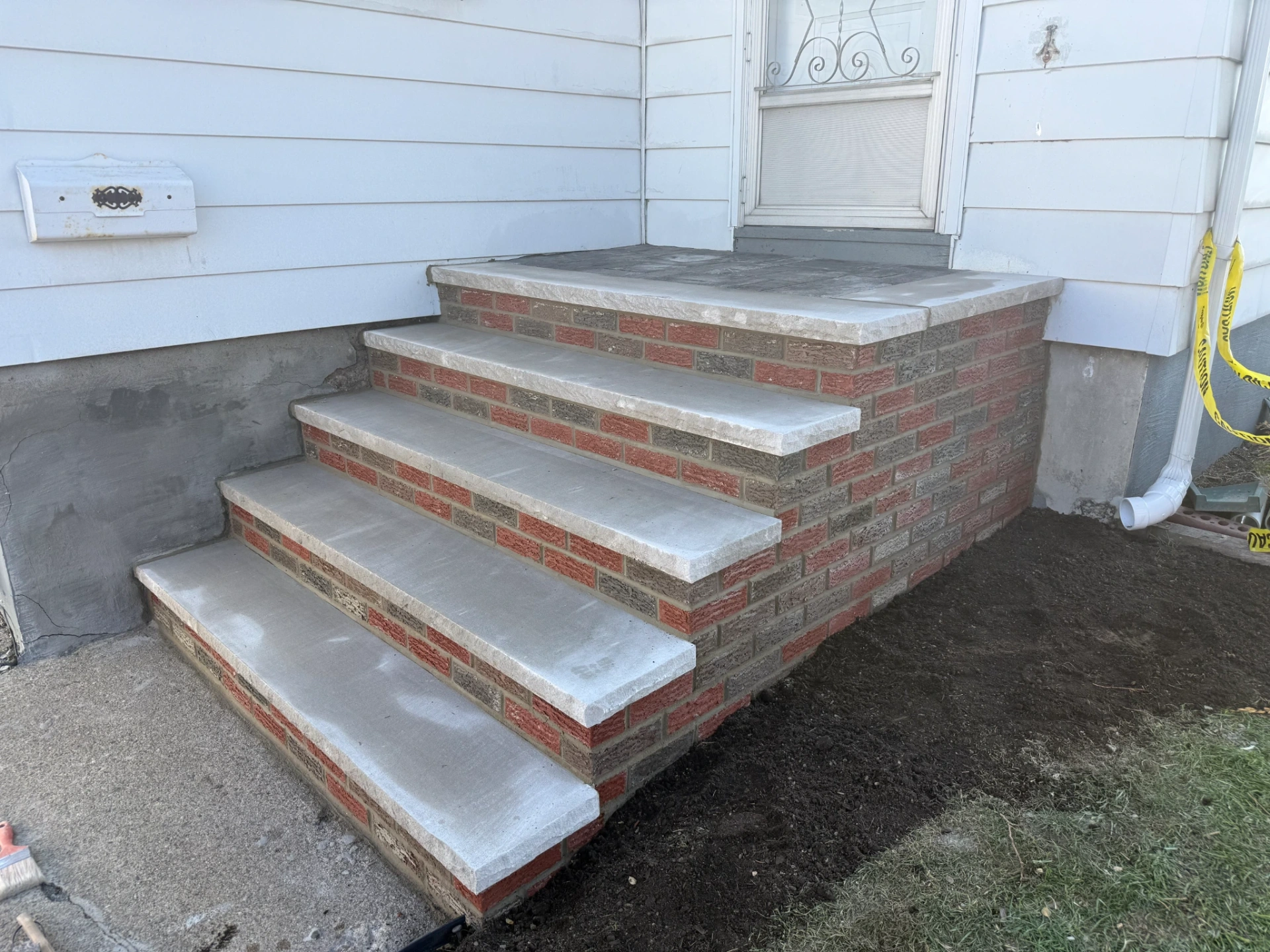 New brick stoops and steps installation with concrete treads at a residential home in Totowa, Passaic County, NJ, by Masonry Pro Construction.